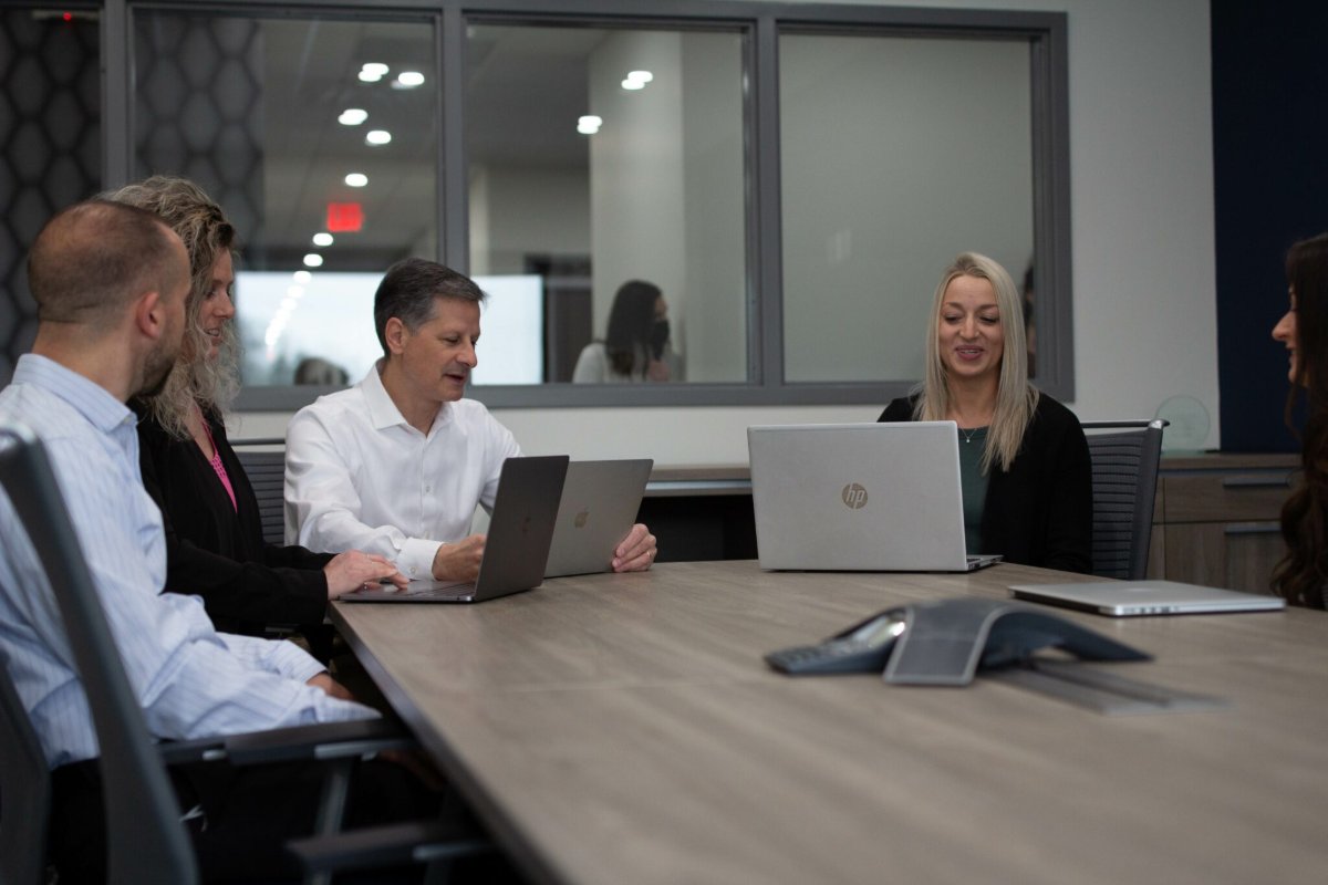 An M.A. Polce engineer working with a client’s in-house IT lead at a desk