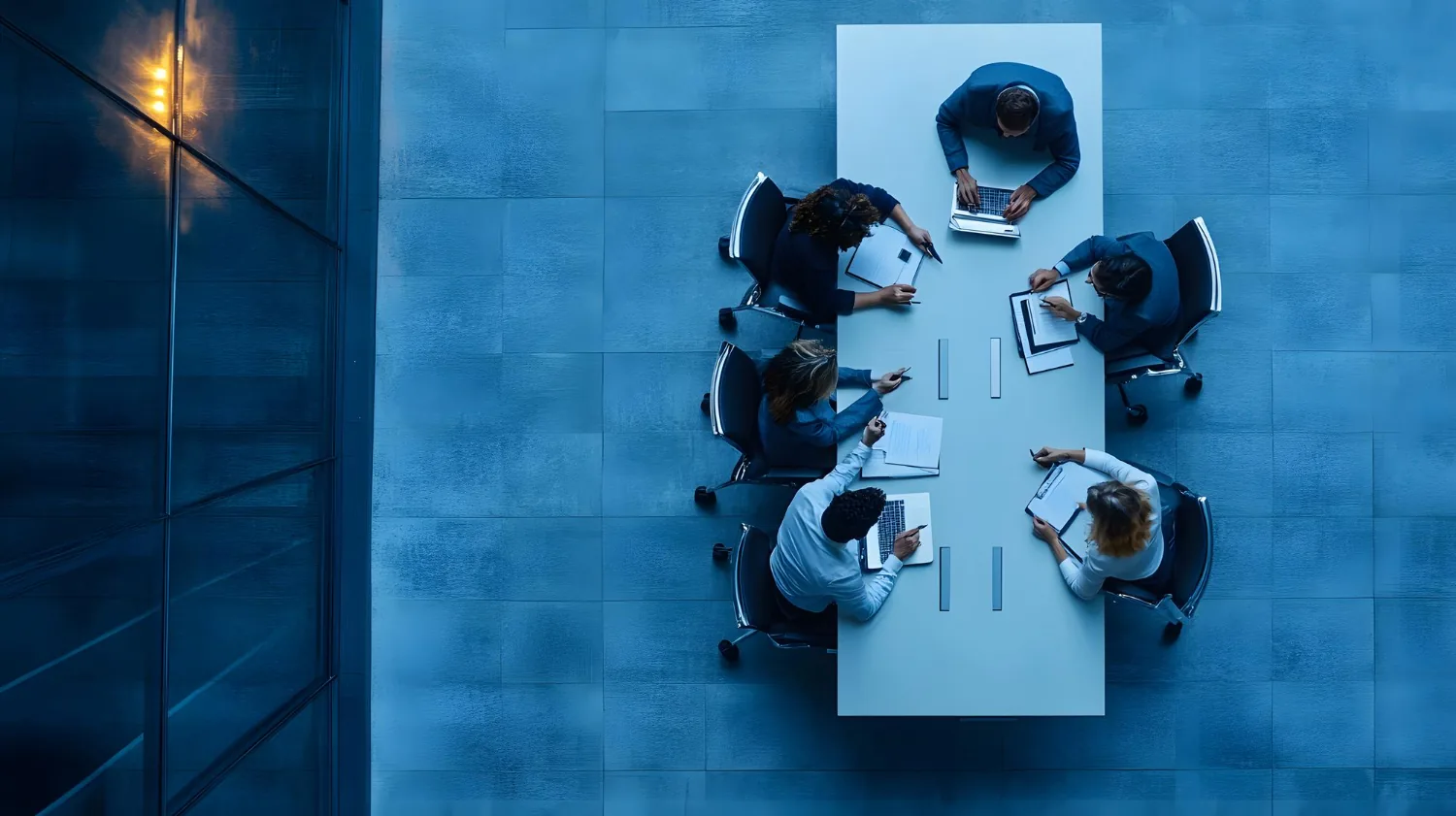 A local government team meeting around a table, seen from above